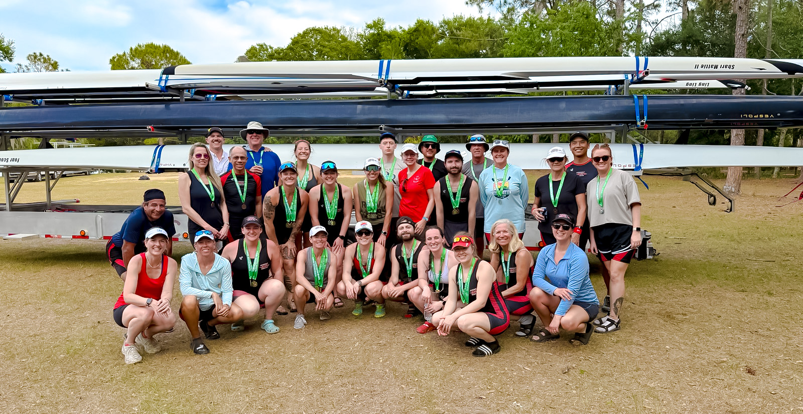 2025 Florida Masters Regatta Group Photo - Crop Group shot of JRC racers in front of shell trailer, wearing their medals.