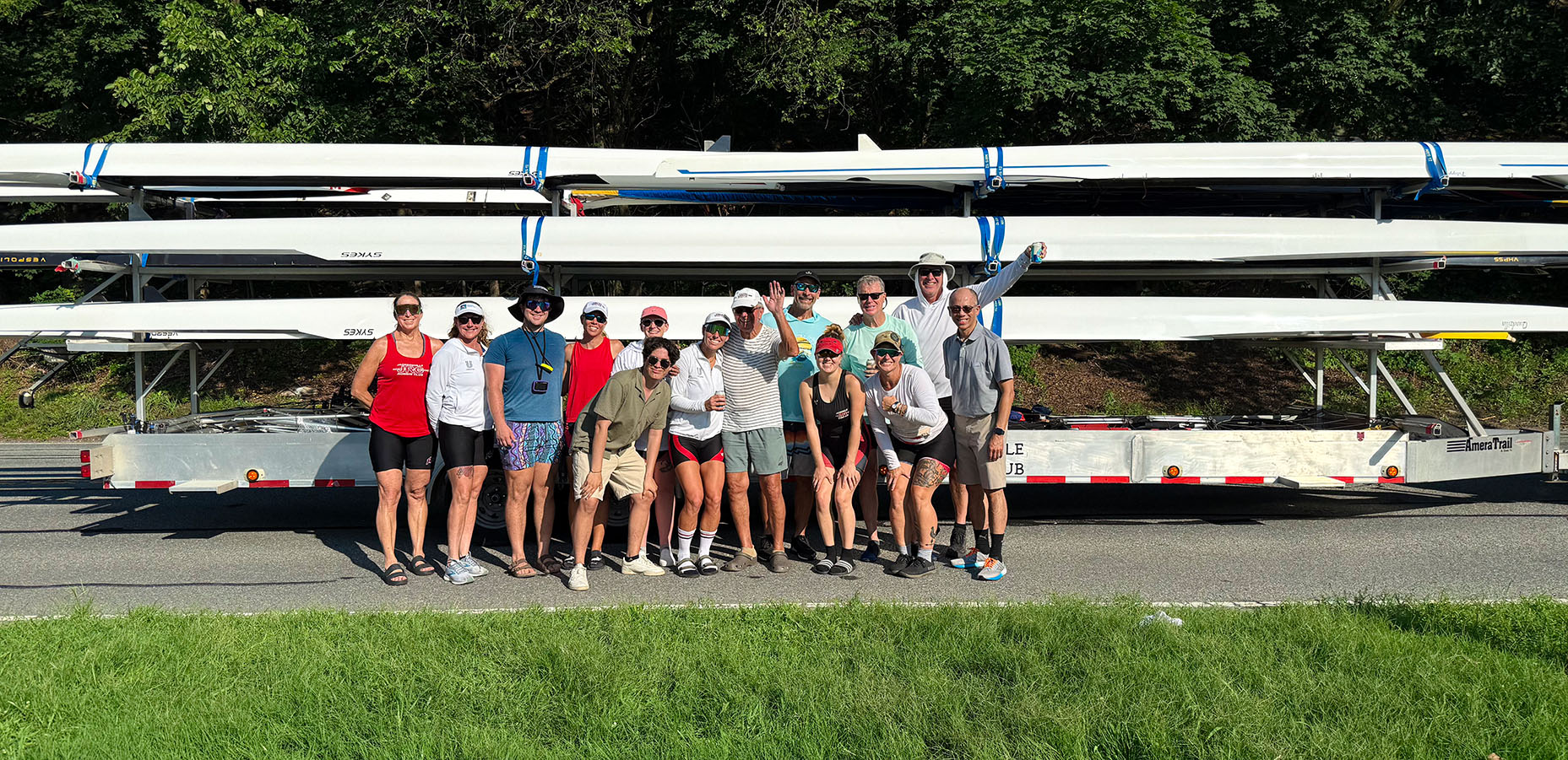 JRC IDR 2025 1 - Edit Web JRC racers posing for a group shot in front of their trailer loaded with rowing shells